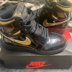 Black and metallic gold jordan 1s
